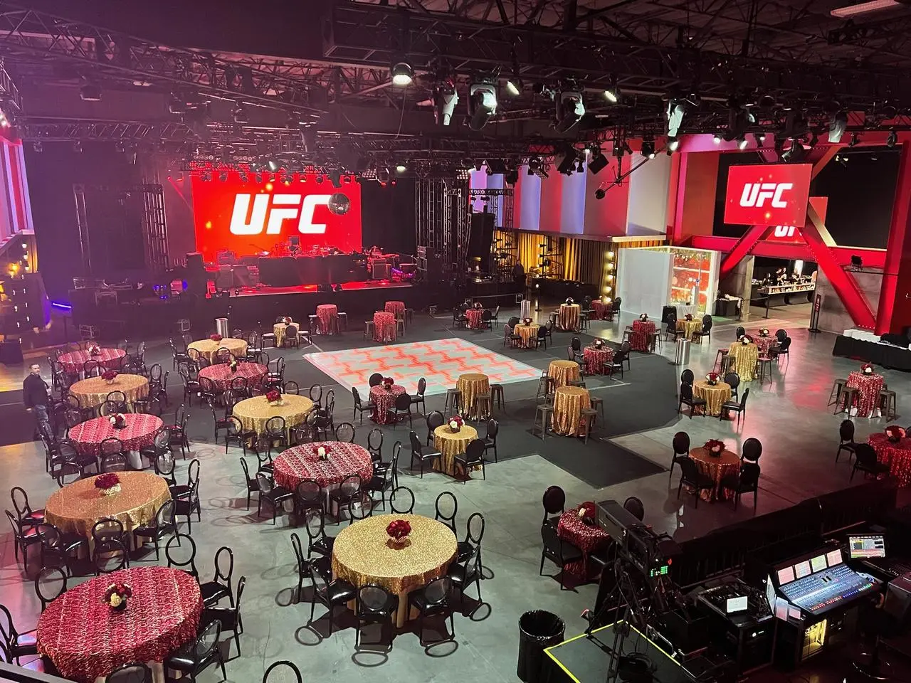 UFC-themed indoor gala with LED screens, gold and red tables for event production in Las Vegas