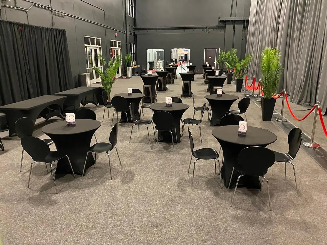 Indoor Event Black Tables Chairs Green Plants Event Production Las Vegas
