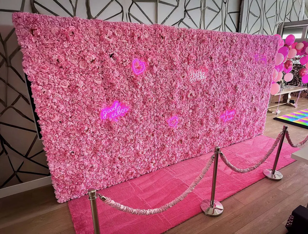 Pink flower wall with neon signs for birthday party event design in Las Vegas